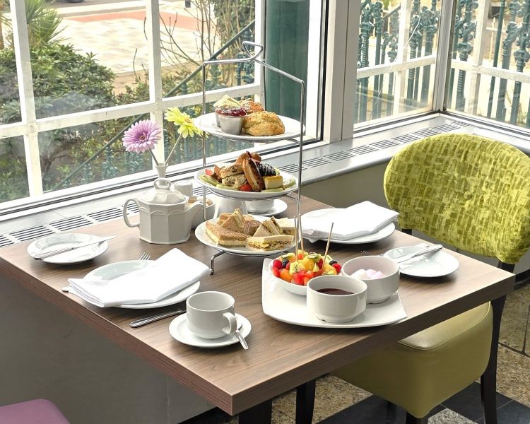 a deluxe afternoon tea laid out on a table
