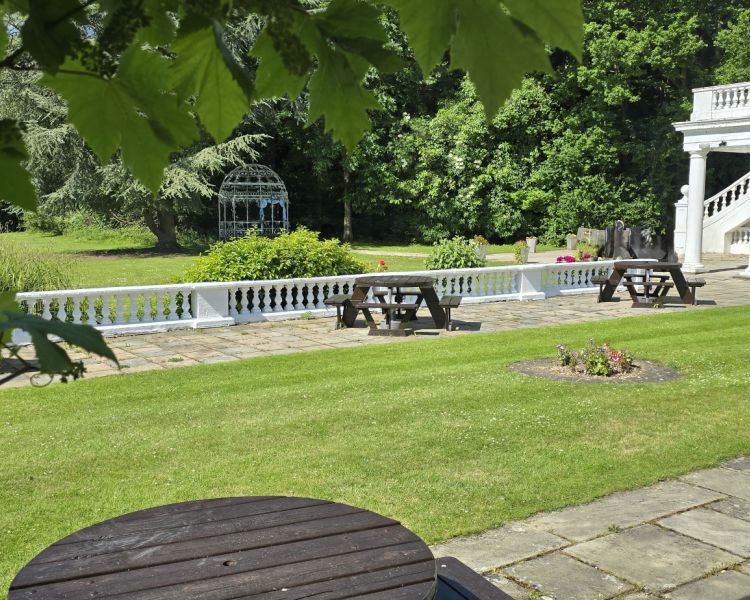 the gardens of a manor house hotel in hertfordshire