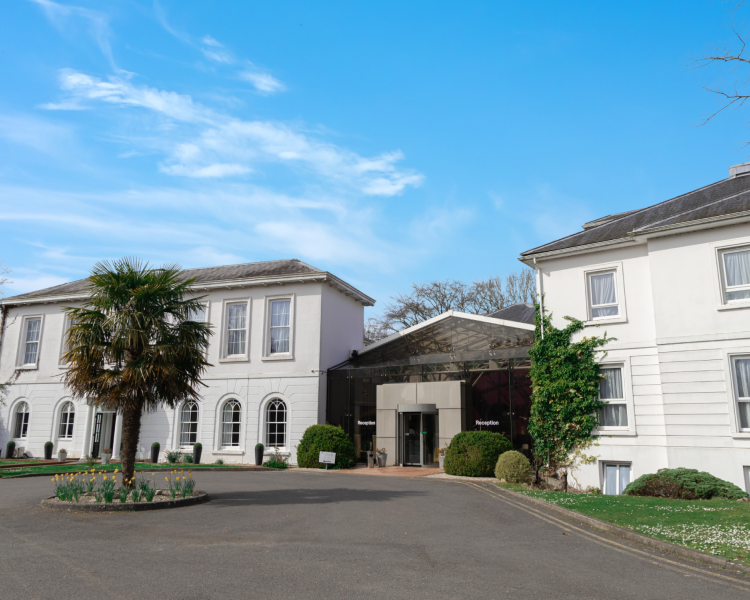 the front of a manor house hotel in hertfordshire