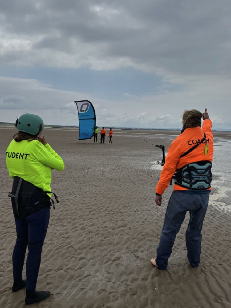 students on the beach on a kitesurfing experience