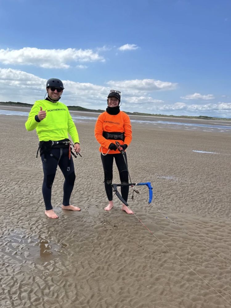 a woman and an instructor on a kitesurfing experience