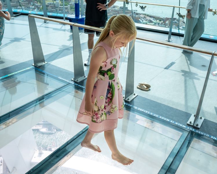 A child braves Spinnaker Towers glass floor