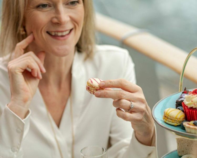 High Tea Mum eating Macaron