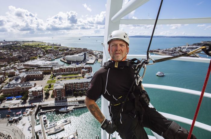 An instructor abseiling down Spinnaker Tower