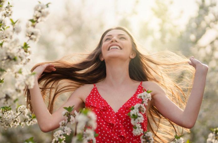 Woman throwing her hair back in the sunshine