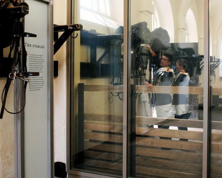 a view of the displays in the stables showing saddles hung on the wall at the household cavalry museum