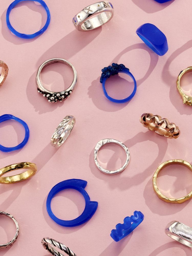 a selection of gold and silver rings and their wax ring models shown as examples of what you can make on a ring making experience
