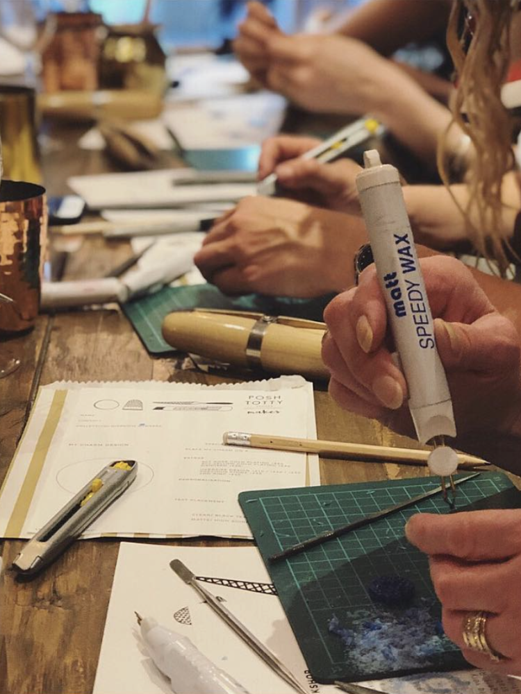 people making their personalised rings on a jewellery making experience