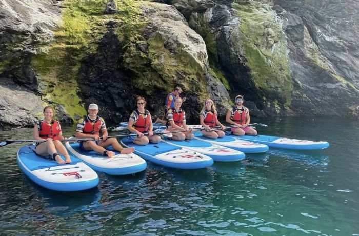 group of people sat on paddle boards