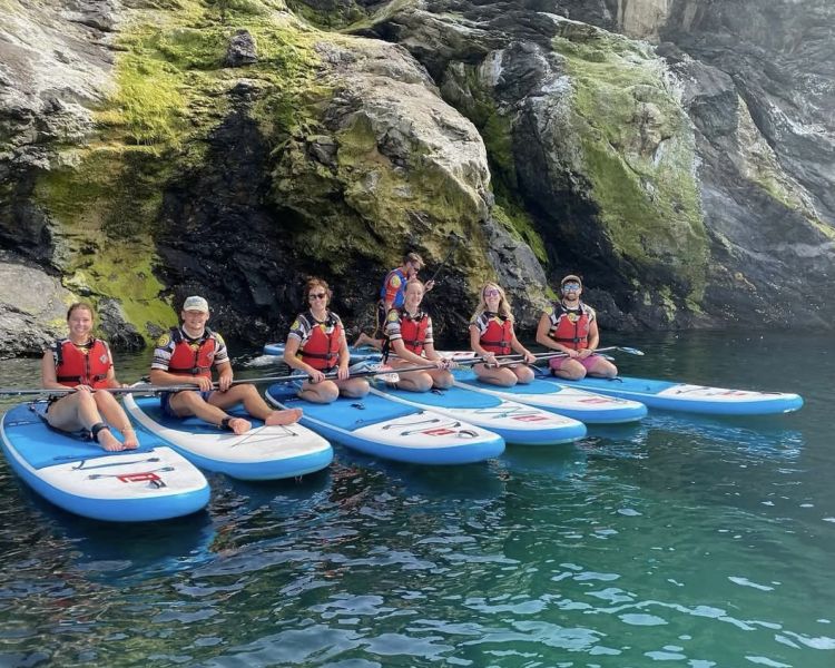 group of people sat on paddle boards
