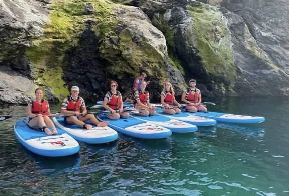 group of people sat on paddle boards