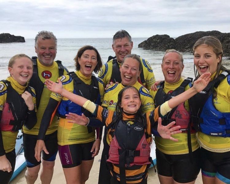 Group of people on the beach wearing life jackets