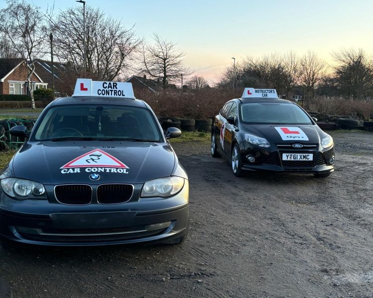 two cars used for skid pan driving experiences
