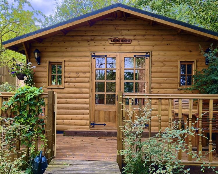 view of lions house wooden cabin for a glamping experience in cambridgeshire