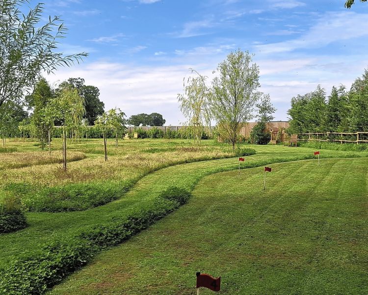 the gardens with putting green of a glamping site in cambridgeshire