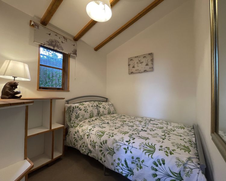 the bedroom with double bed in beavers house on a glamping experience in cambridgeshire