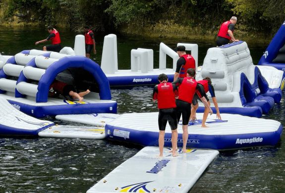 People playing on inflatable waterpark