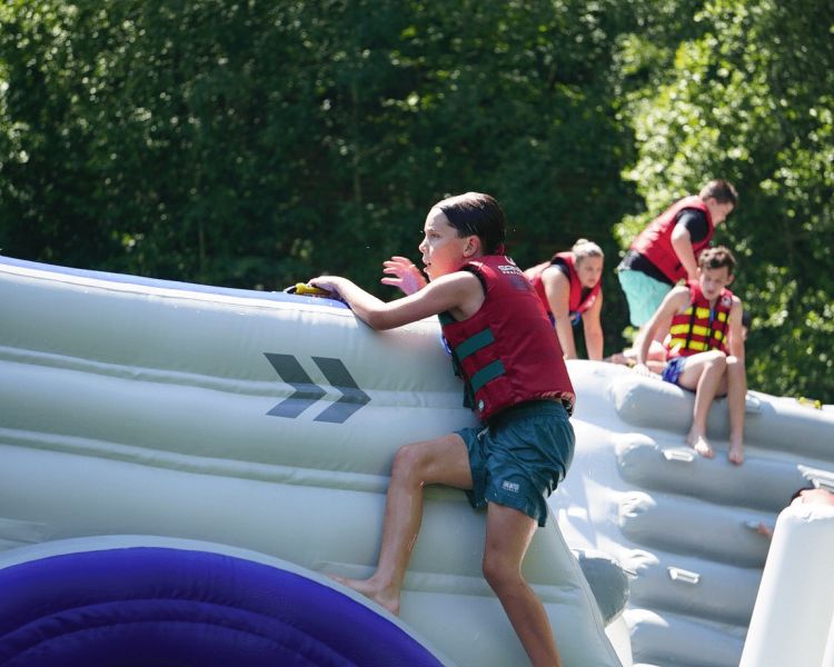 Kids playing on inflatable water park