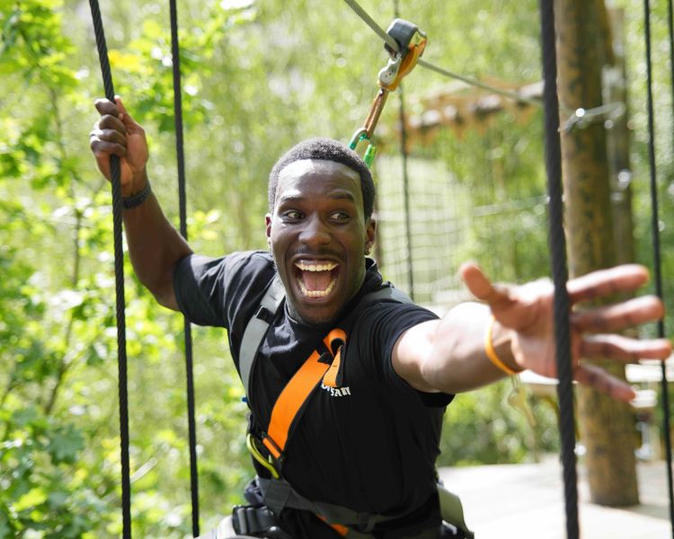 Man on high ropes course