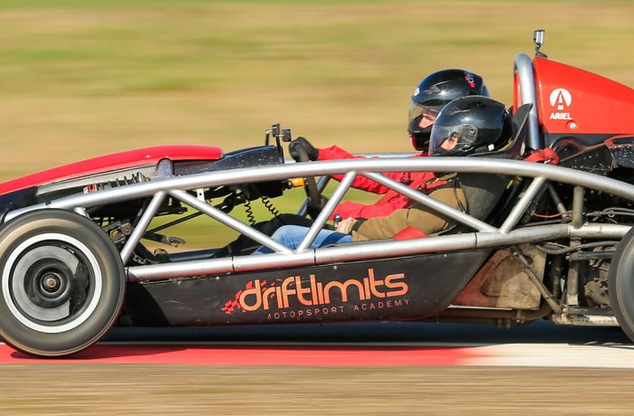 side view of a race car being driven on a race track