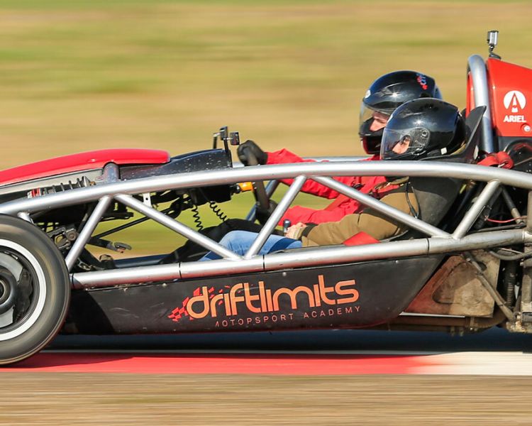 side view of a race car being driven on a race track