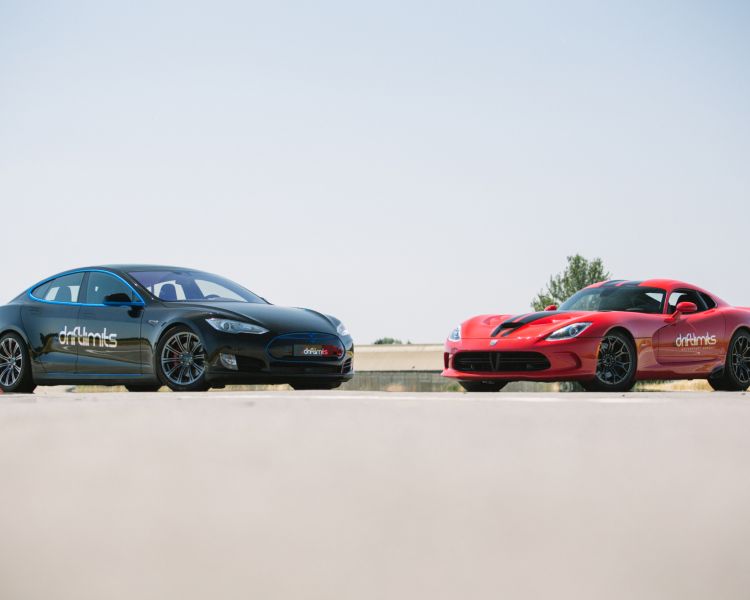 far away shot of a tesla and a viper, two supercars, head to head on a race track