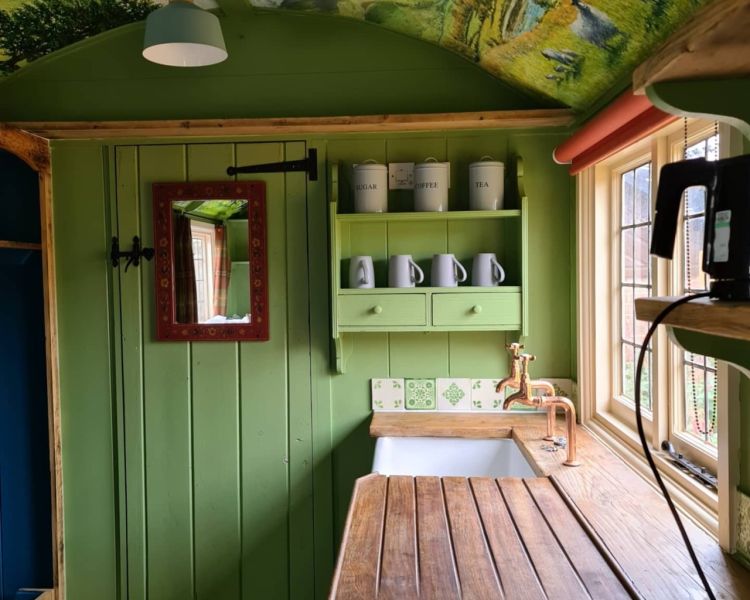 The kitchen area with tea and coffee making facilities inside the shepherds hut used for short stays near stonehenge