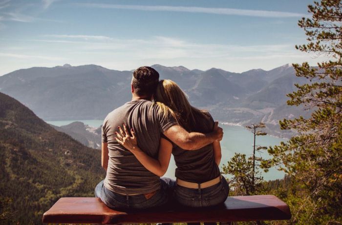 Couple sat in front of mountain view