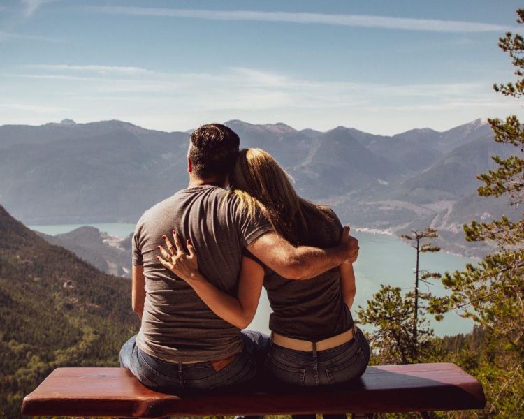 Couple sat in front of mountain view