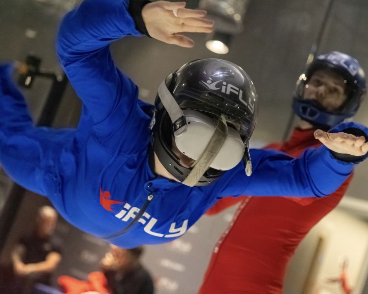 person on an indoor skydive wearing a vr headset