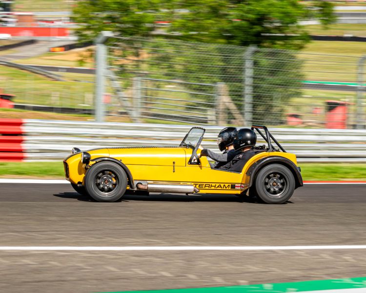 a caterham seven on the race track for a driving experience