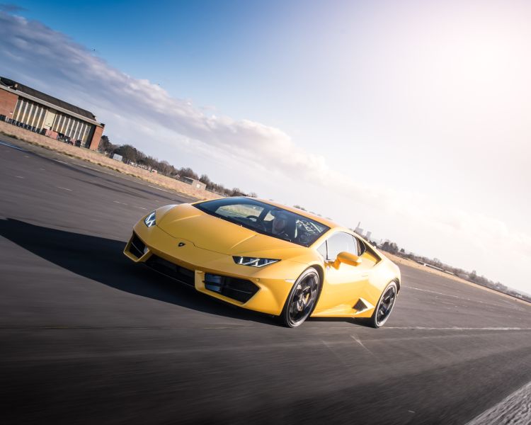 a yellow lamborghini on a race track for a driving experience day