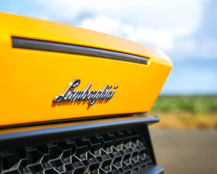 the back of a yellow lamborghini on a race track for a driving experience day