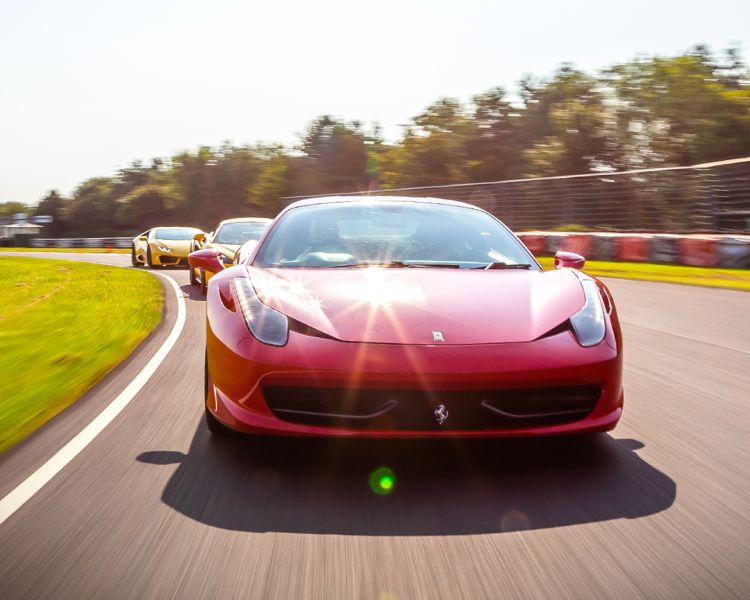 a red ferrari on a race track for a driving experience day