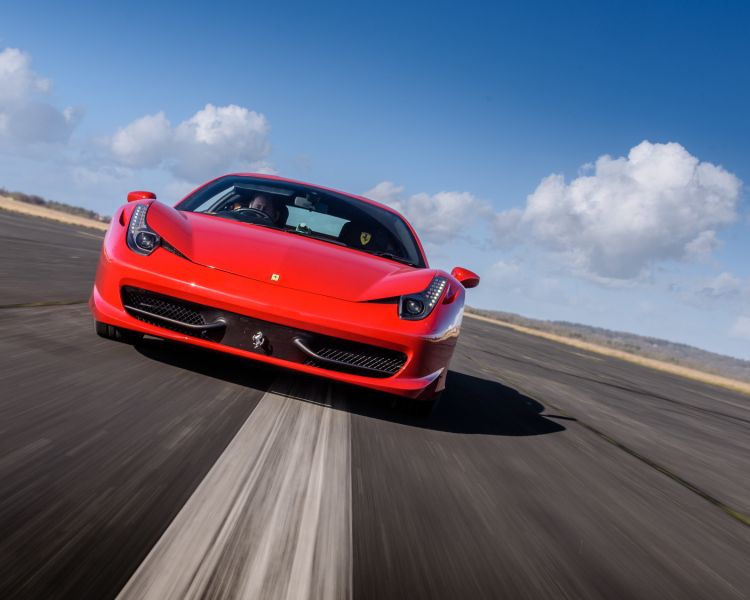 a red ferrari on a race track for a driving experience day