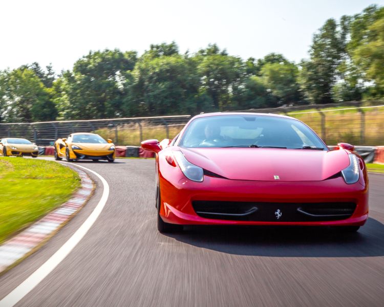 three supercars on a race track for a driving experience