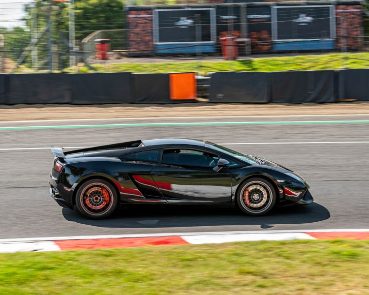 a black supercar on a race track for a premium driving experience