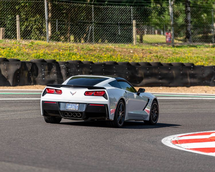 a white supercar on a race track for a premium car driving experience