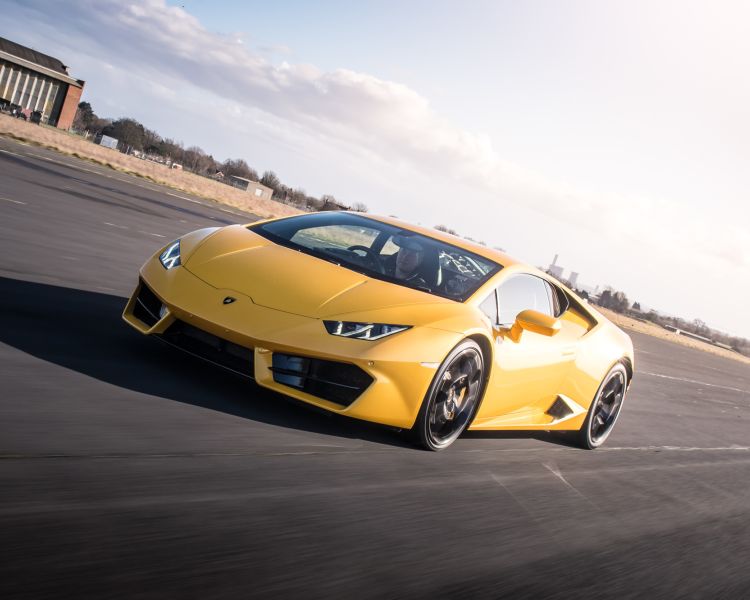 a yellow lamborghini on a race track for a premium car driving experience