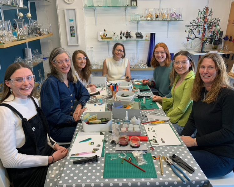 7 people around a table at a fused glass workshop