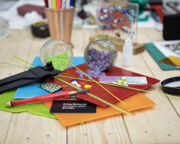 materials used in fused glass workshops laid out on a table