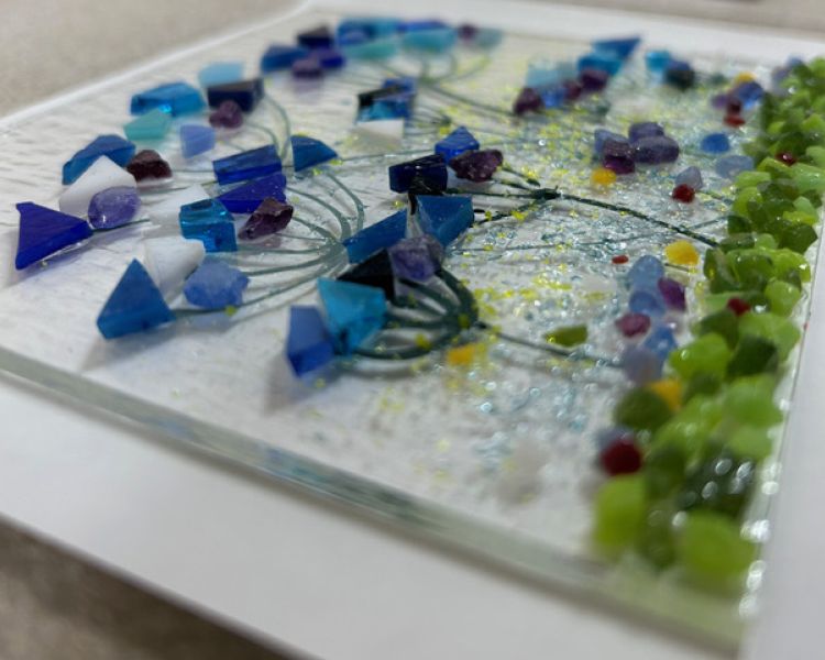a fused glass flower design set on a white background