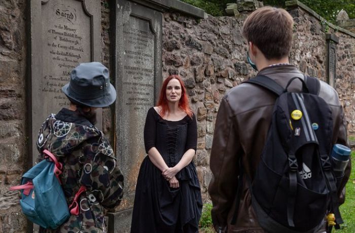 Guide talking to group on a vaults and graveyard walking tour in edingburgh