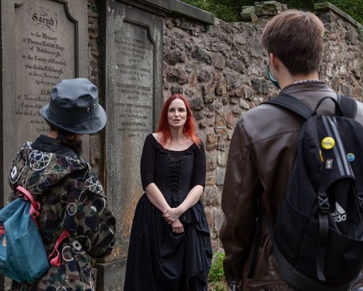 Guide talking to group on a vaults and graveyard walking tour in edingburgh