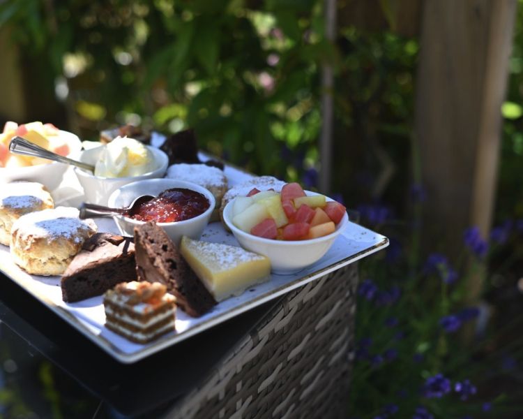 afternoon tea plated up in the garden of the natural light spa