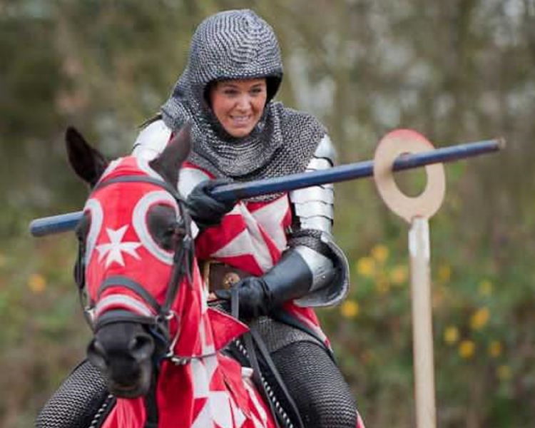 woman on horseback dressed as a medieval knight on a jousting experience