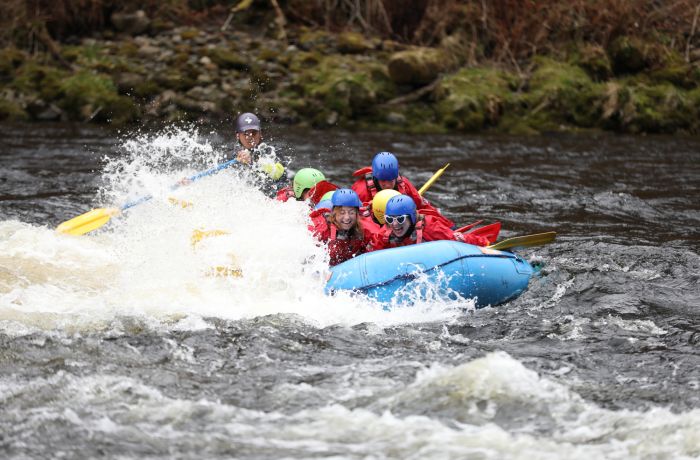 people white water rafting on the river tay in scotland