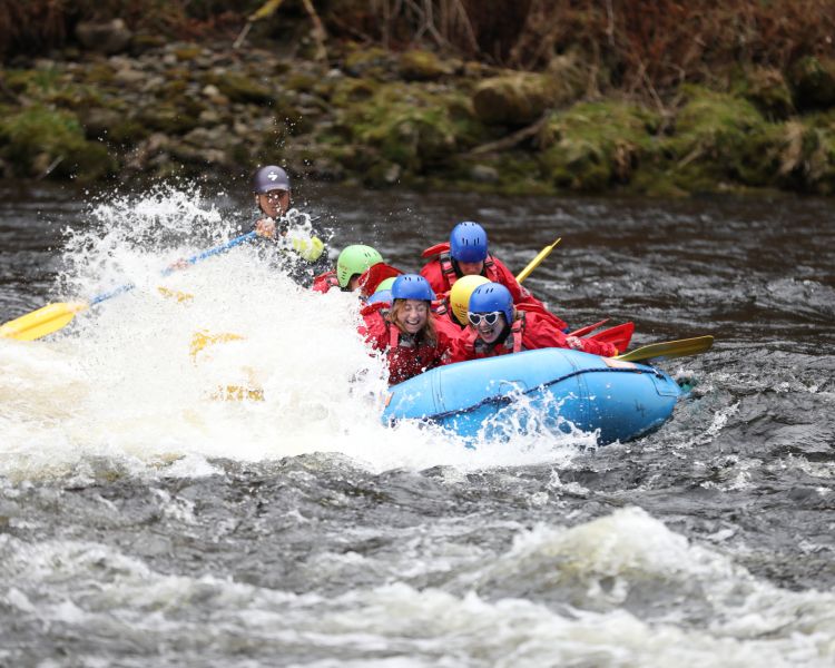 people white water rafting on the river tay in scotland