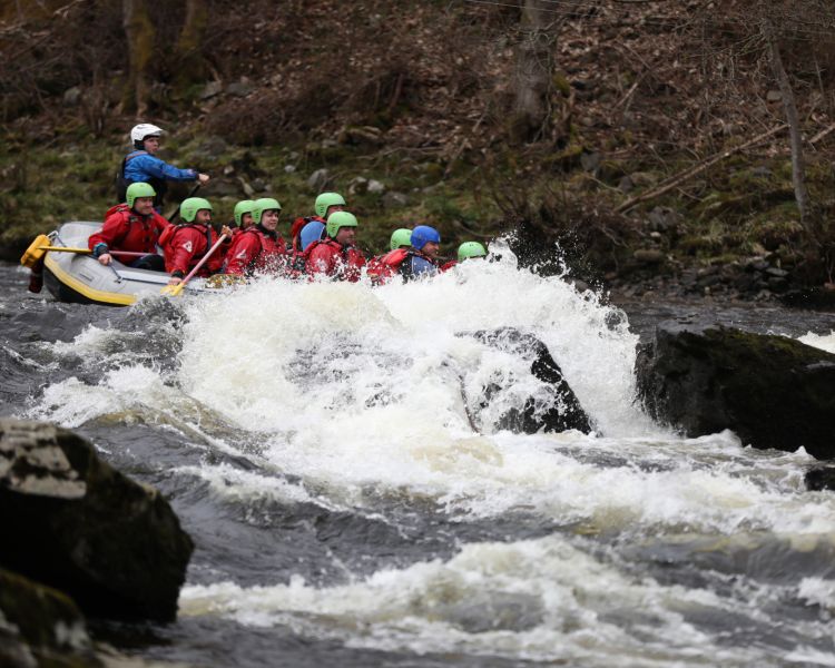 people white water rafting on the river tay in scotland