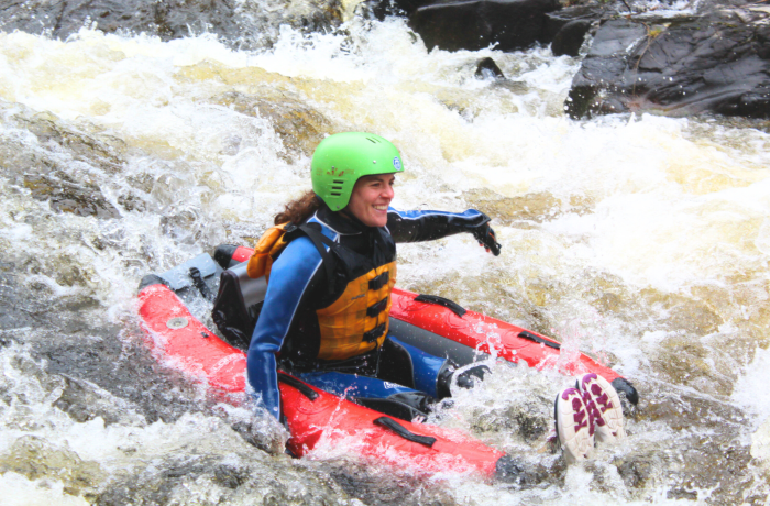 woman on a river bugging experience on the river tummel in scotland